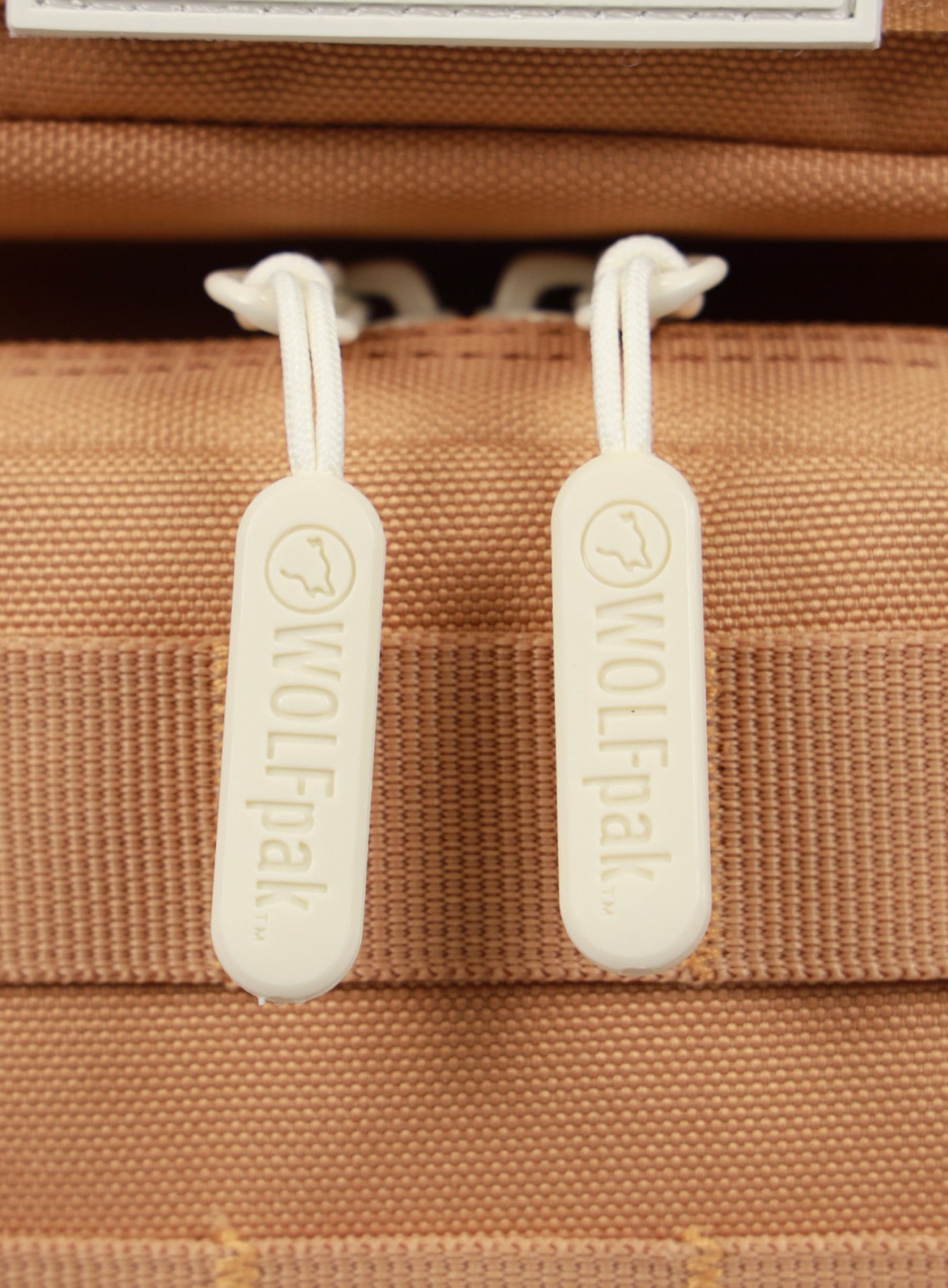 close up picture of the  zipper pull on the 9L Backpack Mini Bombshell Sportswear in Caramel color