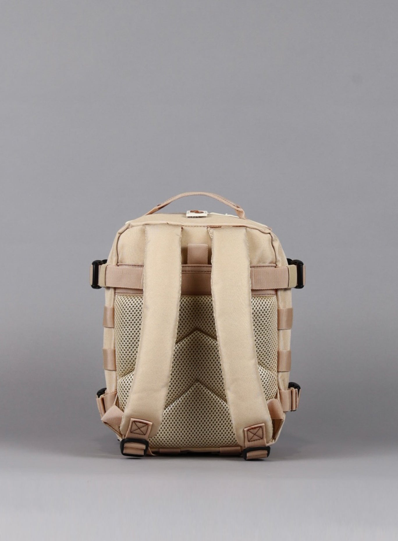 A photo showcasing the rear perspective of the 9L Mini Bombshell Sportswear Latte backpack