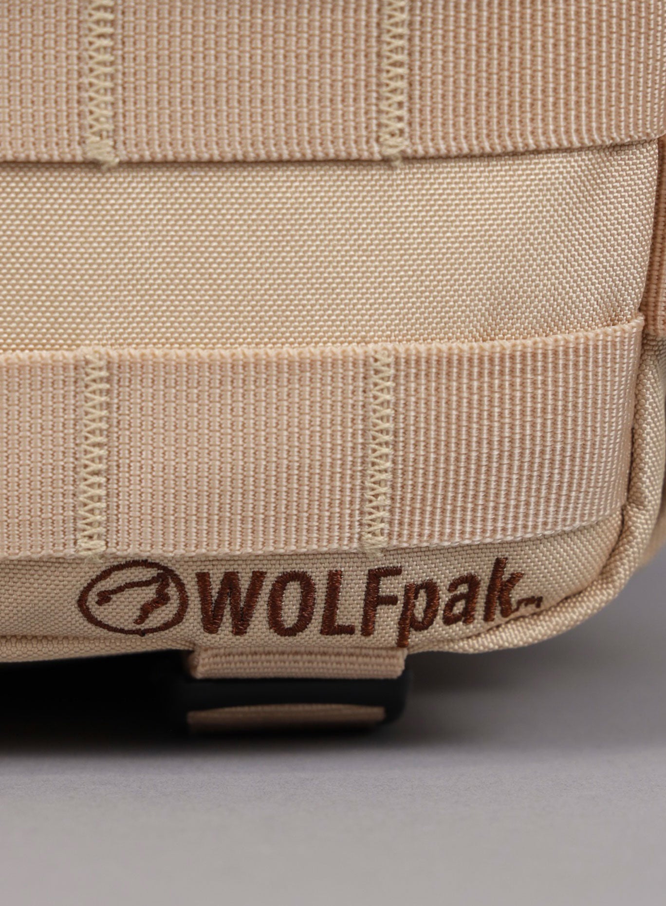 Close up shot of the WOLFpak logo on the 9L Mini Bombshell Sportswear Latte backpack