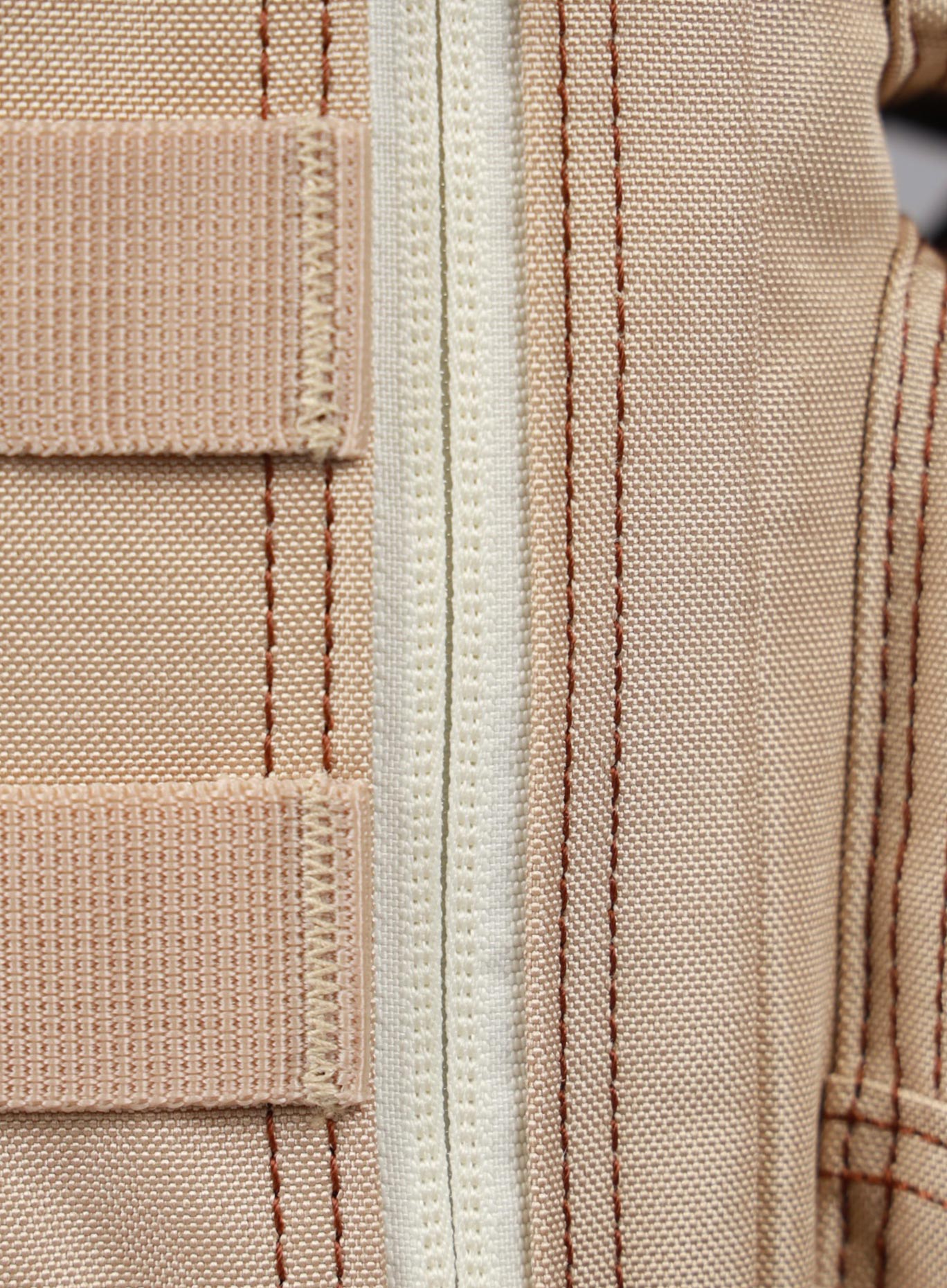 Close up picture of the zip on the 9L Mini Bombshell Sportswear Latte backpack