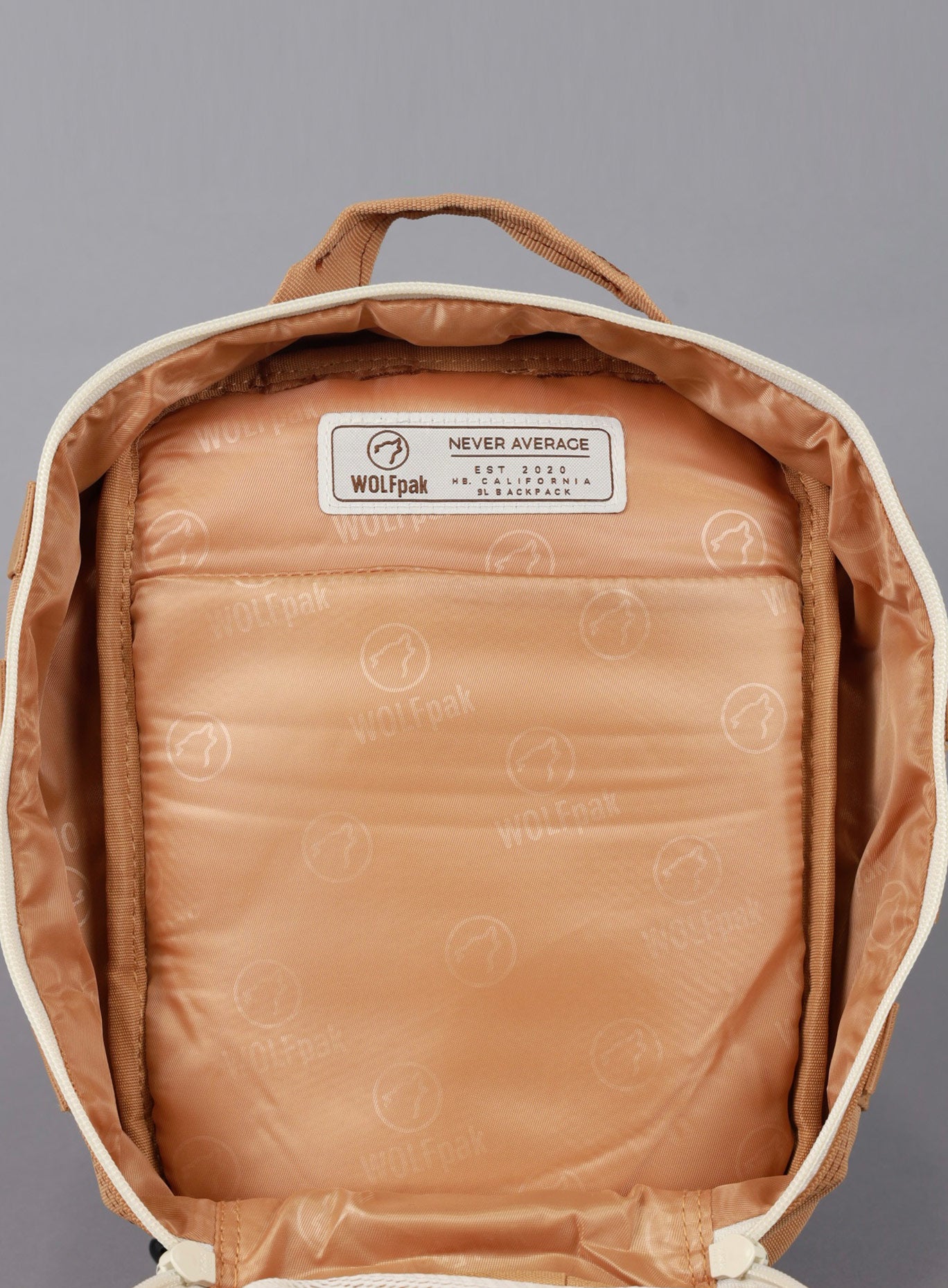 A picture showing the main compartment on the 9L Backpack Mini Bombshell Sportswear in Caramel color unzipped