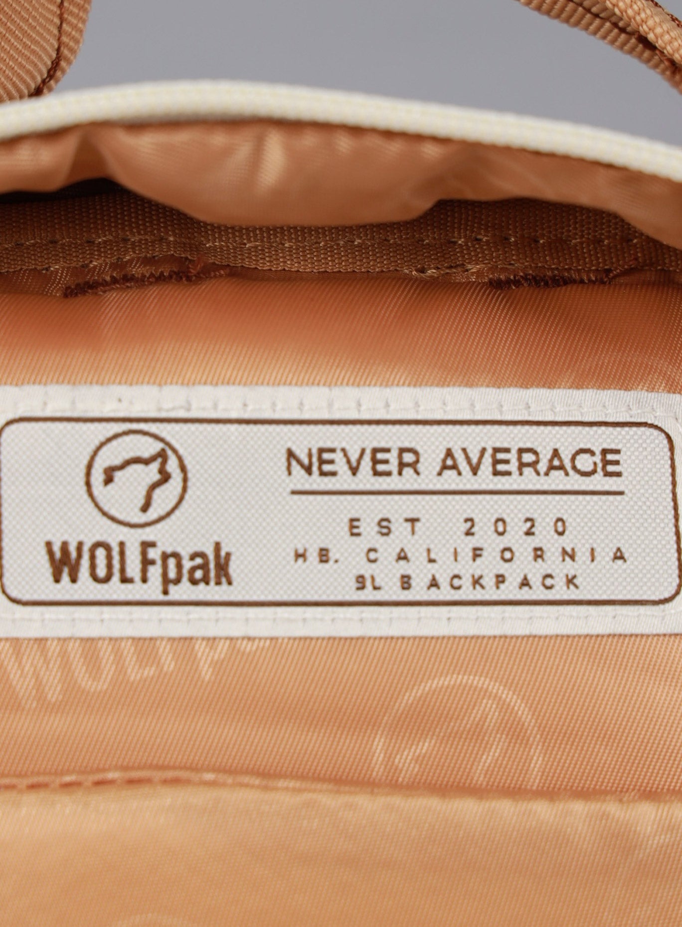 Close up picture of the WOLFpak logo inside the 9L Backpack Mini Bombshell Sportswear in Caramel color