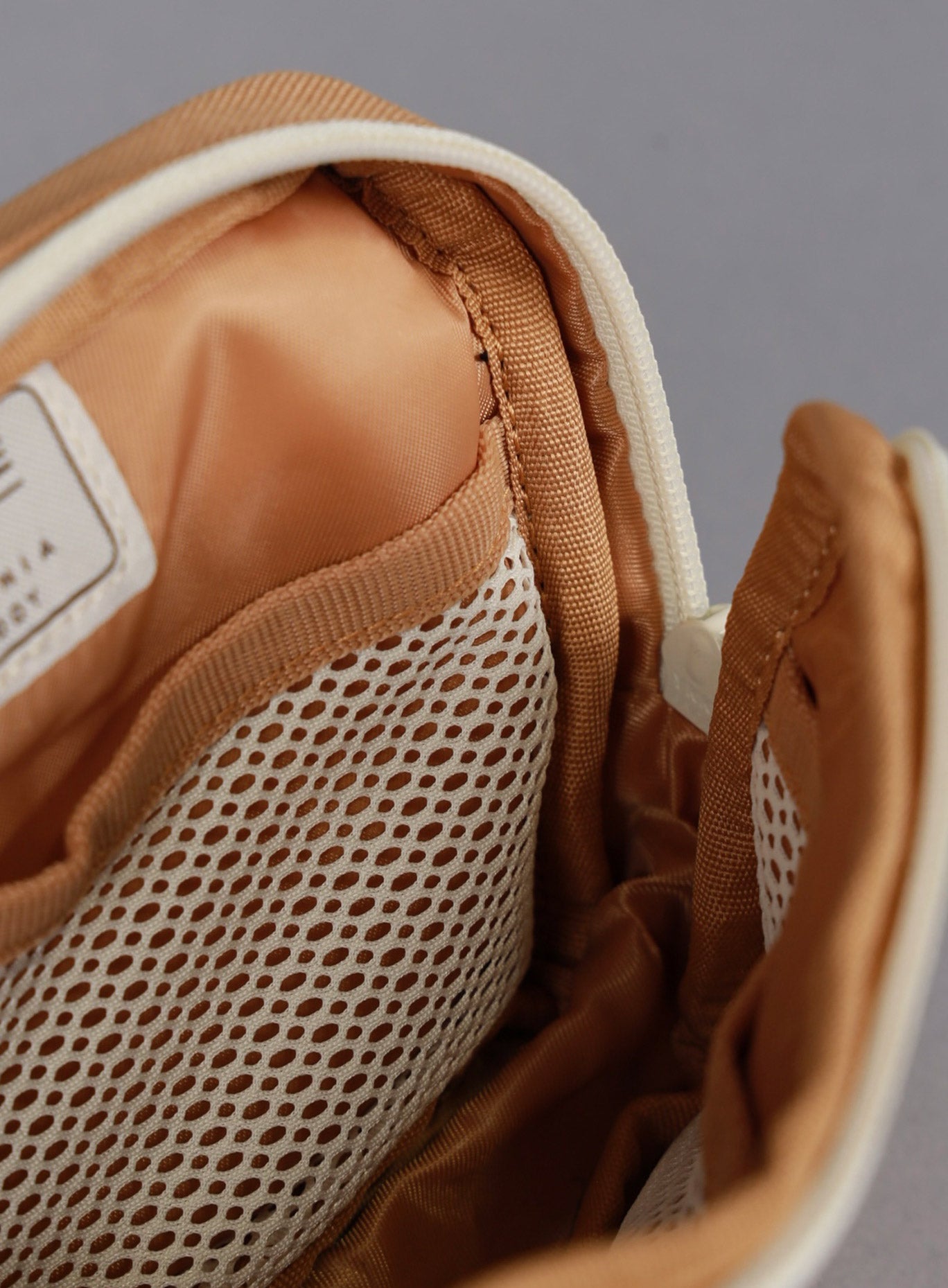 A picture showing the main compartment with mesh on the 1.5L Crossbody Pack Bombshell Sportswear in  Caramel color