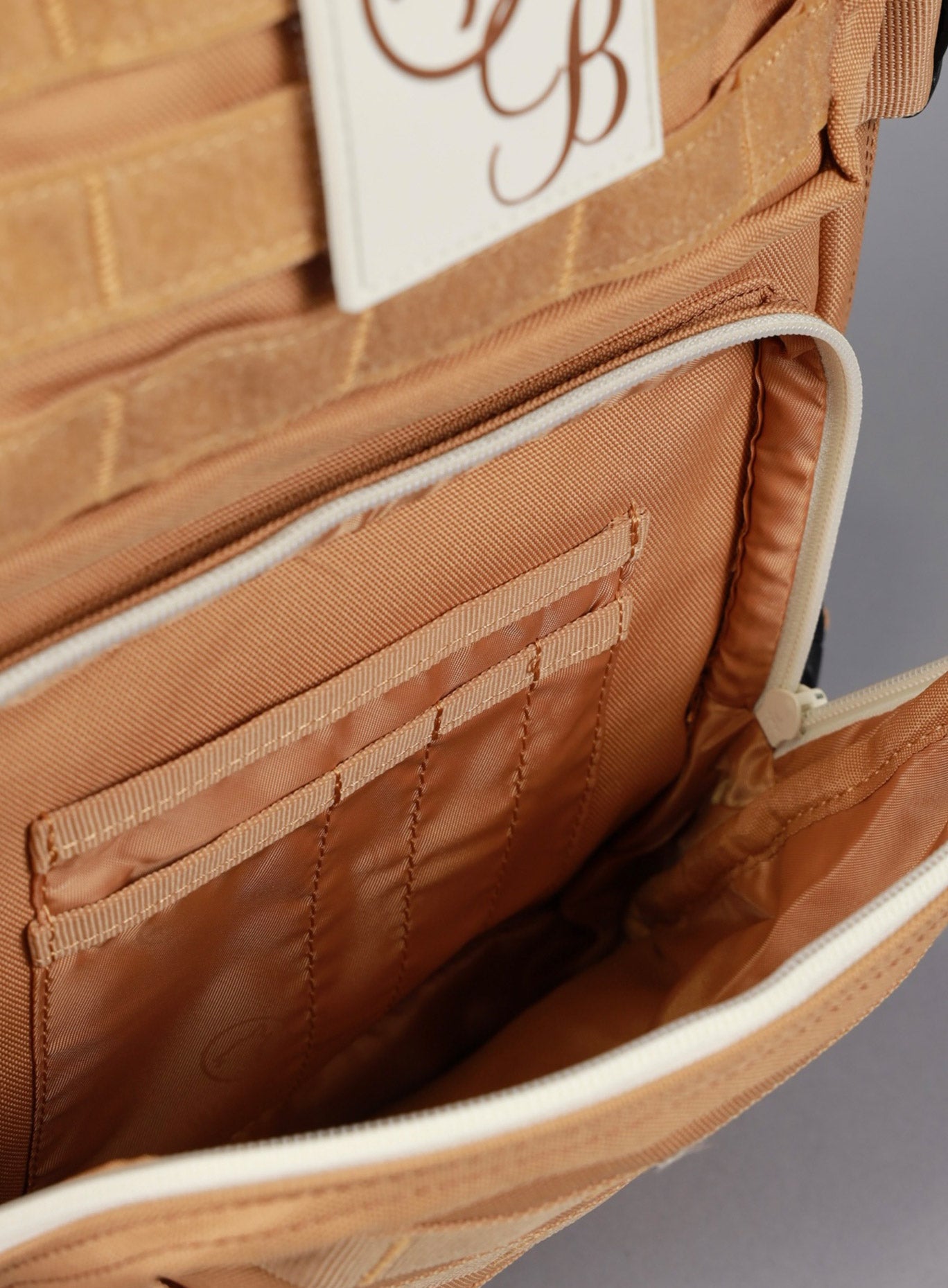 A picture showing the outermost compartment at the bottom on the   25L Backpack Bombshell Sportswear in Caramel color