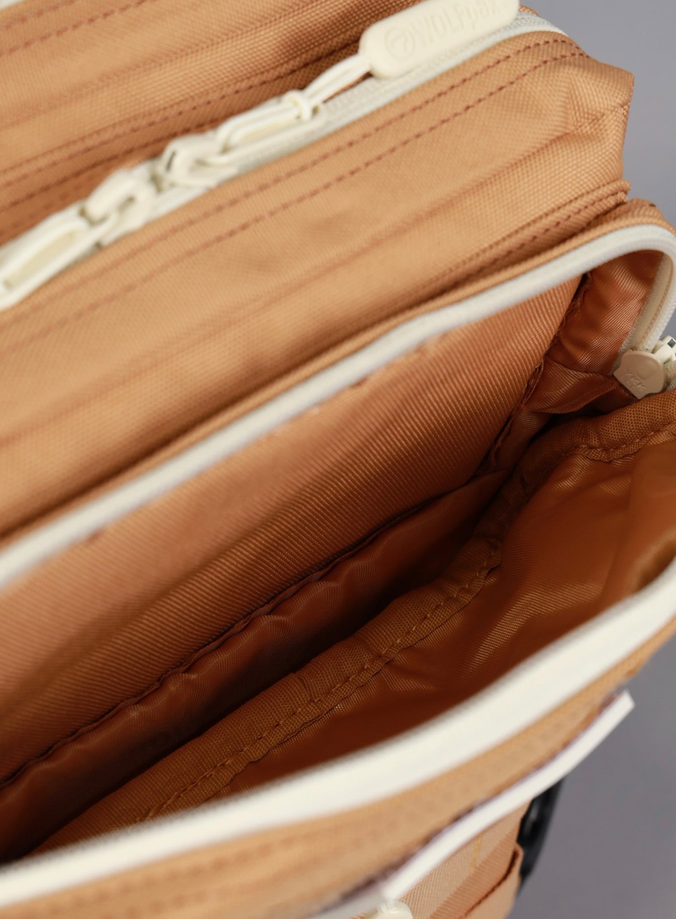 A picture showing the outermost compartment at the top on the   25L Backpack Bombshell Sportswear in Caramel color