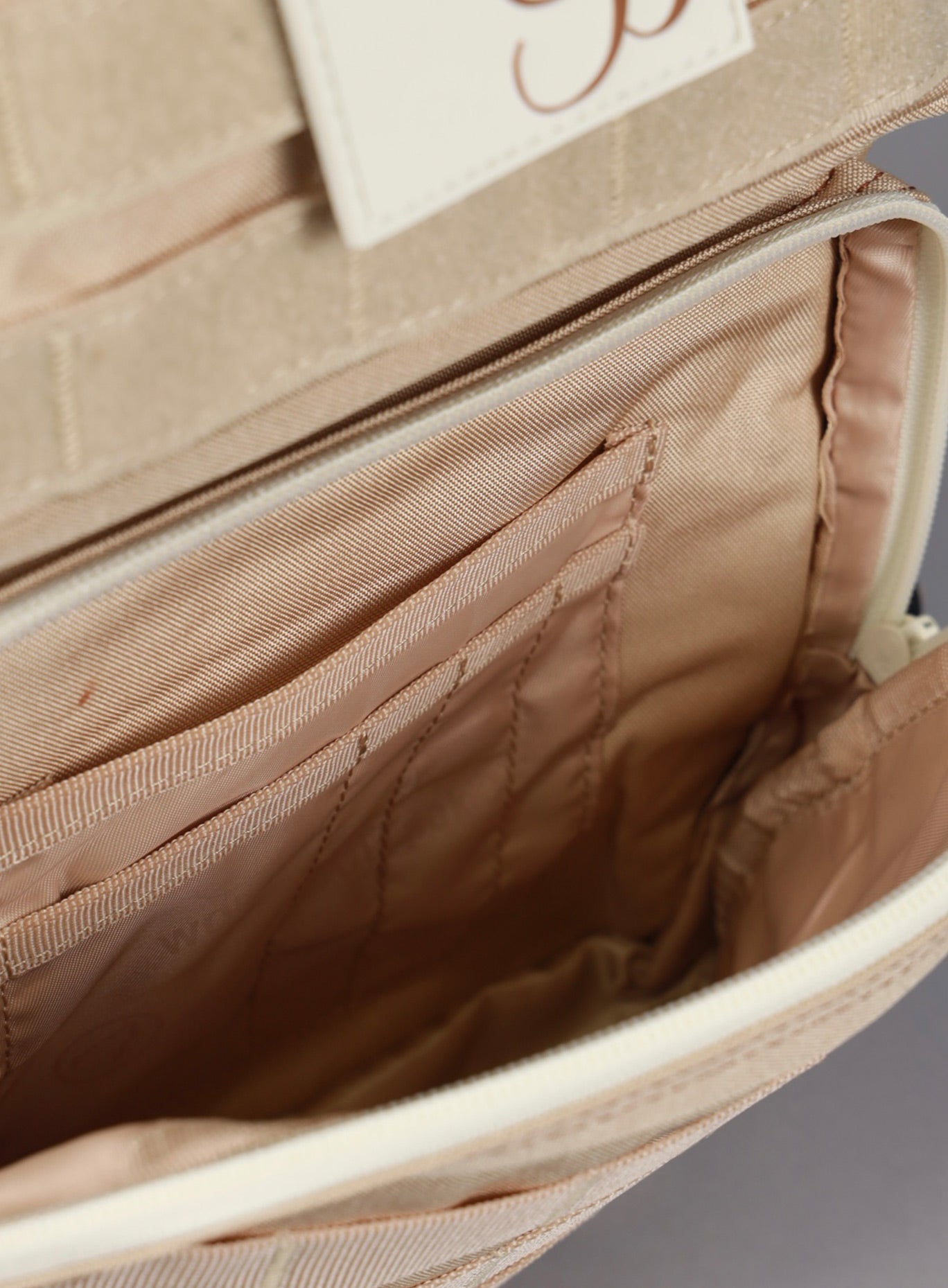 A picture showing the outermost compartment at the bottom on the  25L Backpack Bombshell Sportswear in Latte color