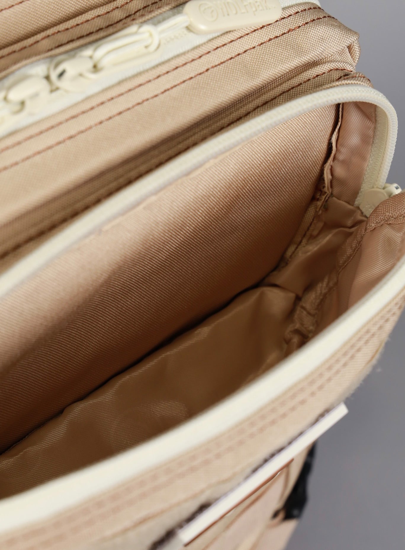 A picture showing the outermost compartment at the top on the  25L Backpack Bombshell Sportswear in Latte color