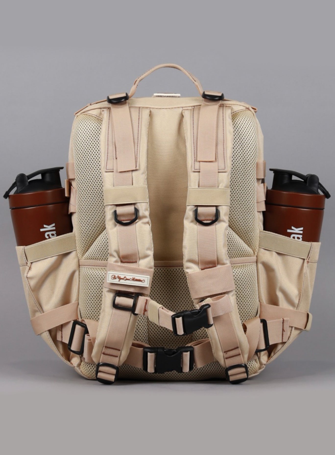 An image showcasing the back angle of the 35L Bombshell Sportswear backpack in Latte