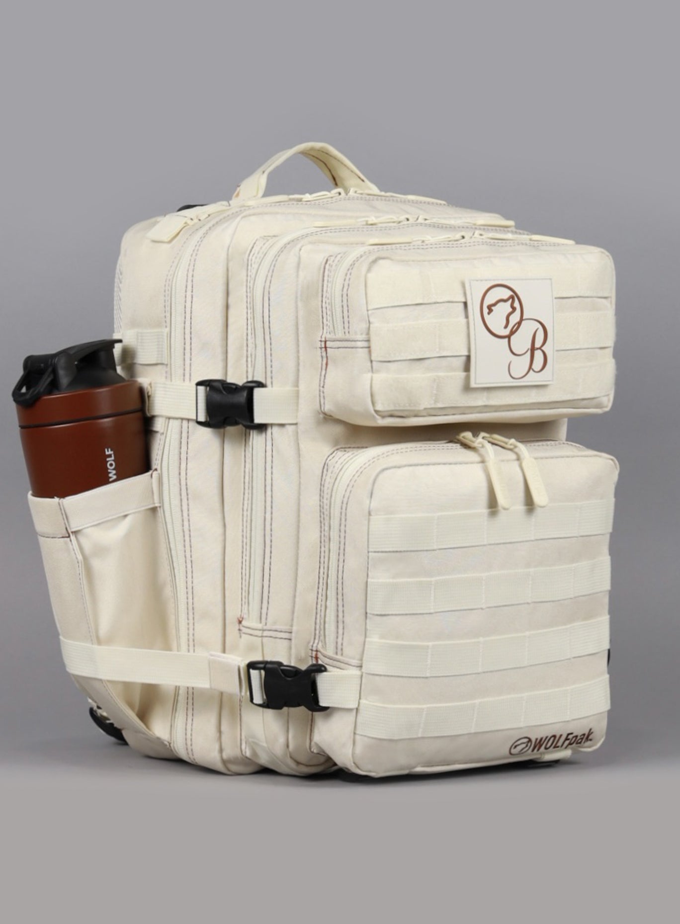 The front left side view of the 35L Backpack Bombshell Sportswear in  Crème color with a water bottle