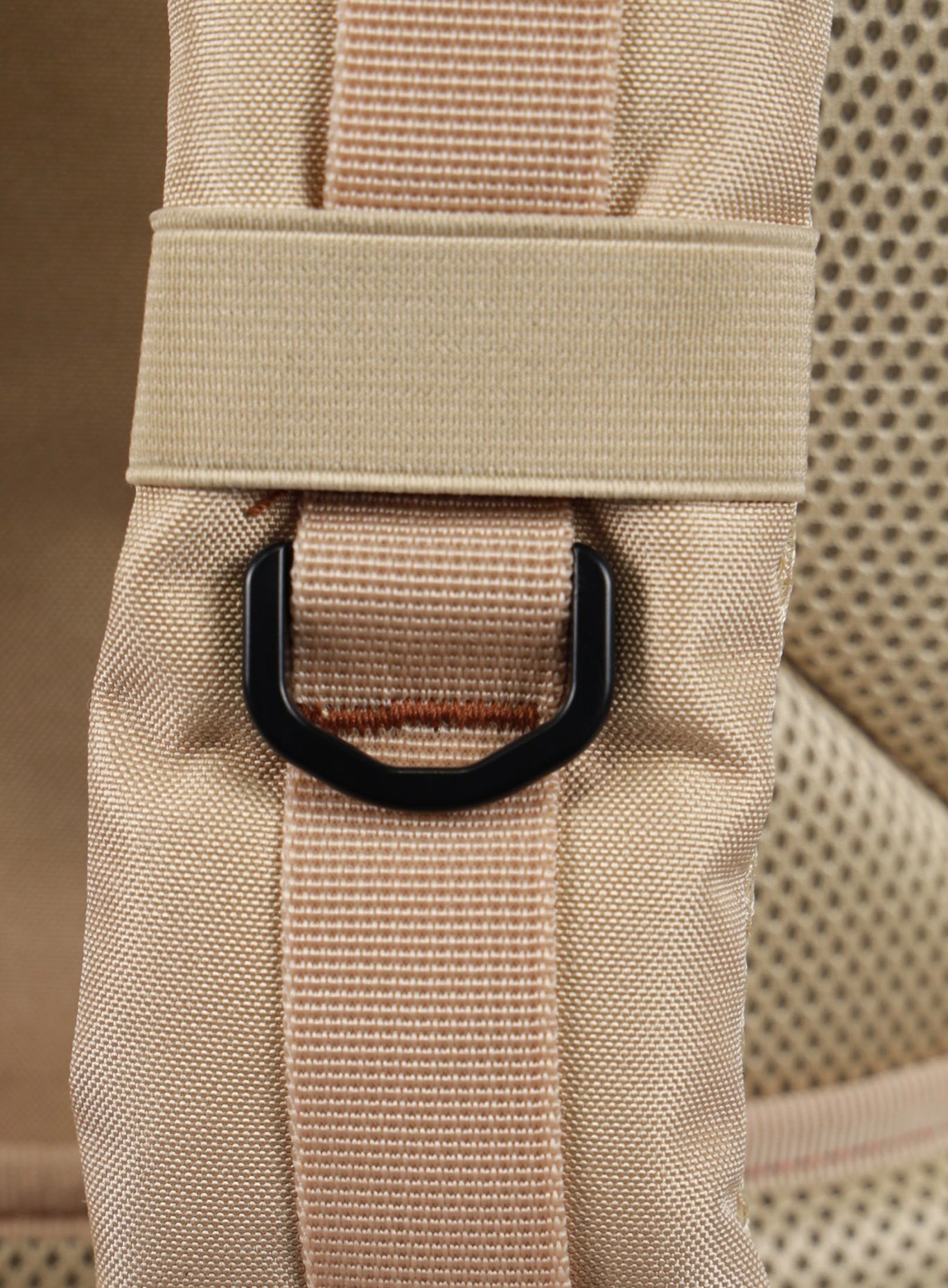 A photo focusing on the shoulder strap of the 35L Bombshell Sportswear backpack in Latte color