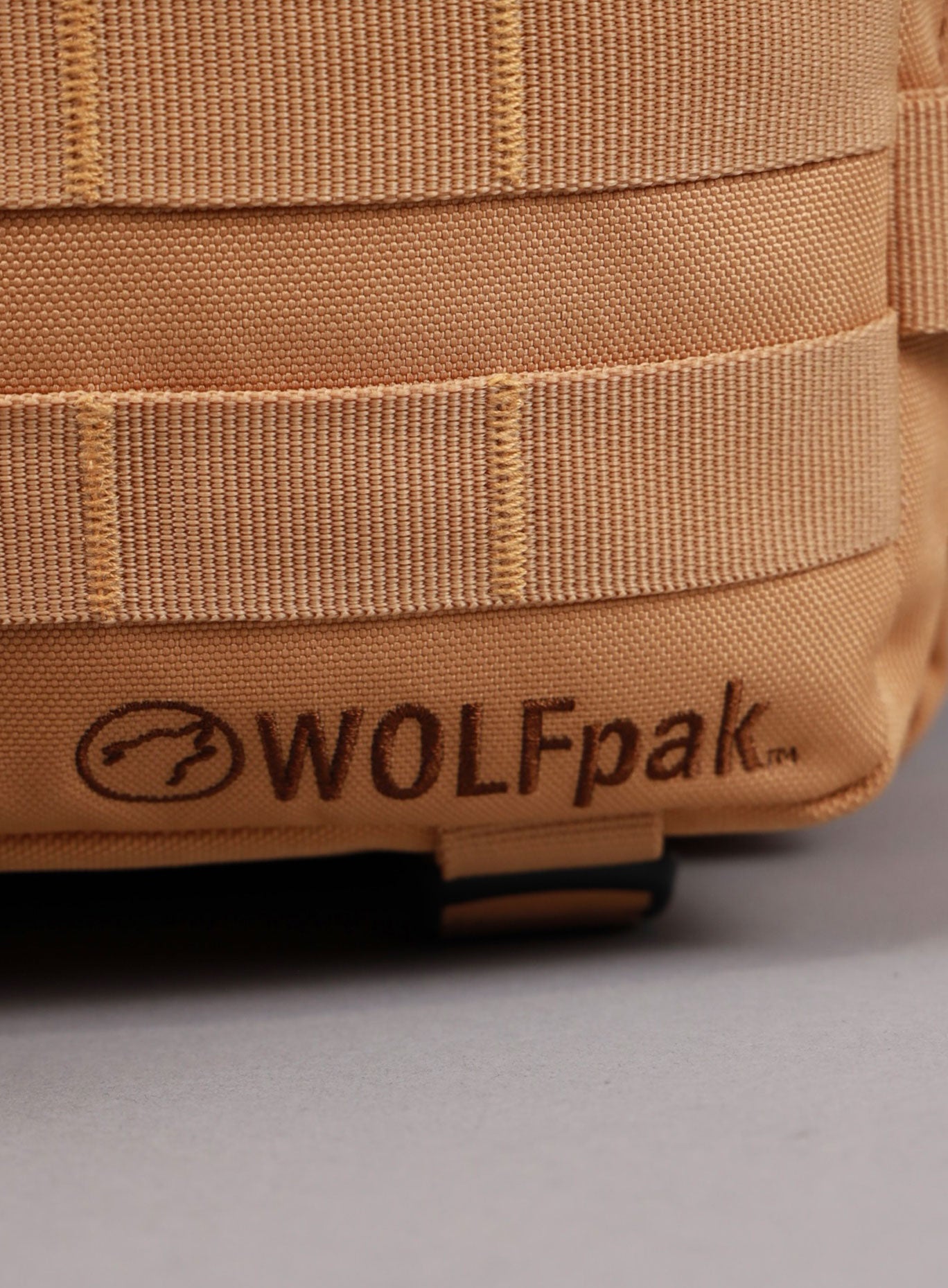 An image highlighting the WOLFpak logo on the 35L Bombshell Sportswear backpack in Caramel color