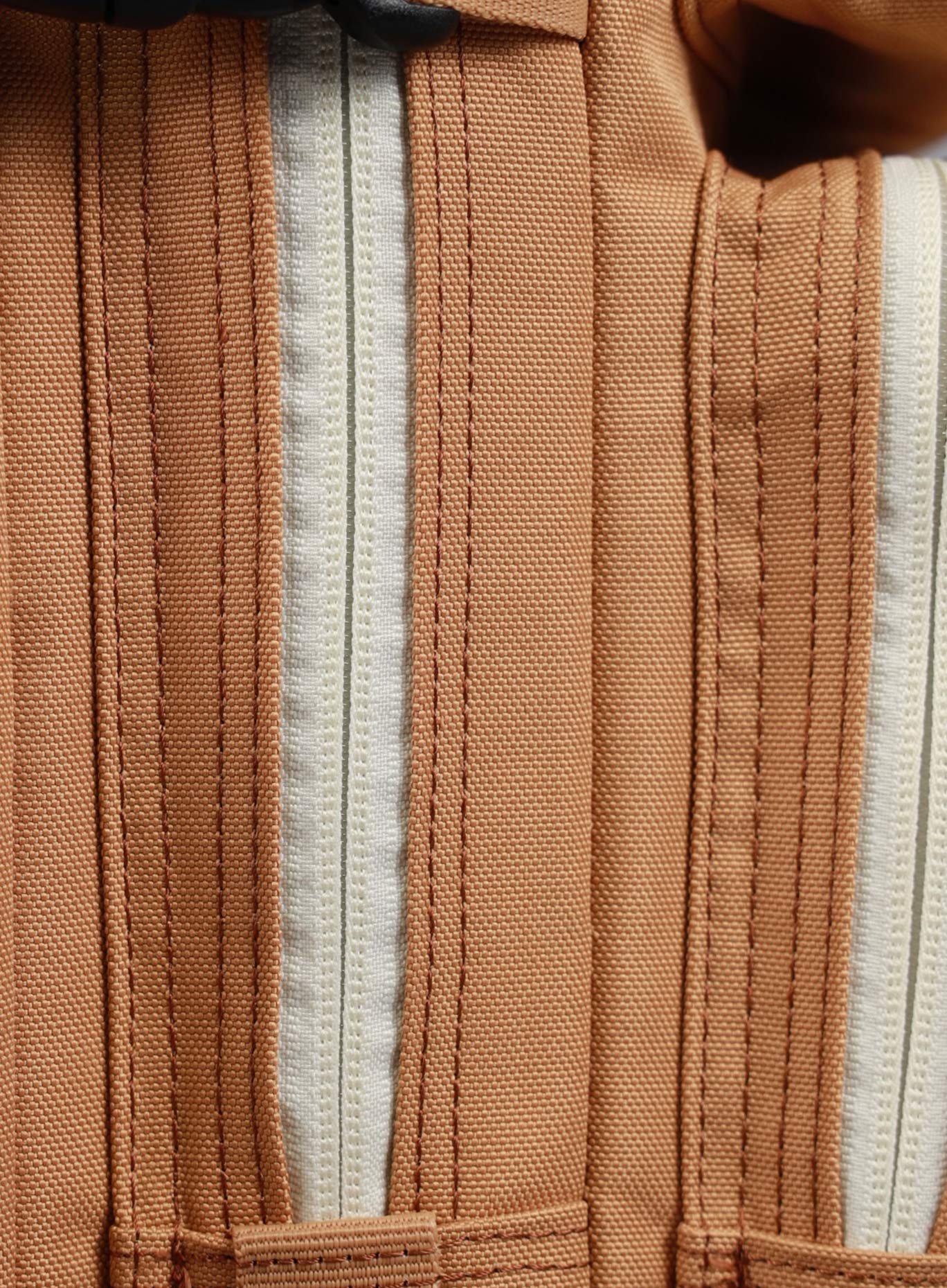 A detailed  image highlighting the zipper of the 35L Bombshell Sportswear backpack in Caramel
