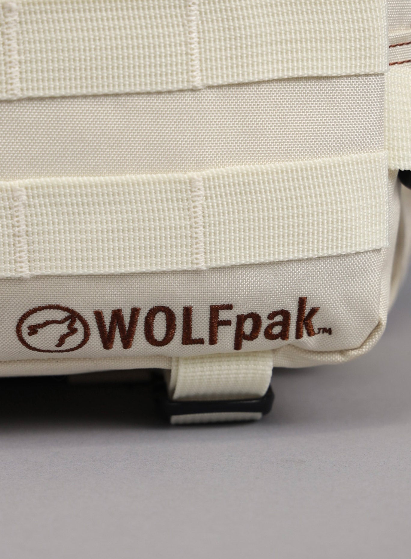 An image highlighting the WOLFpak logo on the 35L Bombshell Sportswear backpack in  Crème color