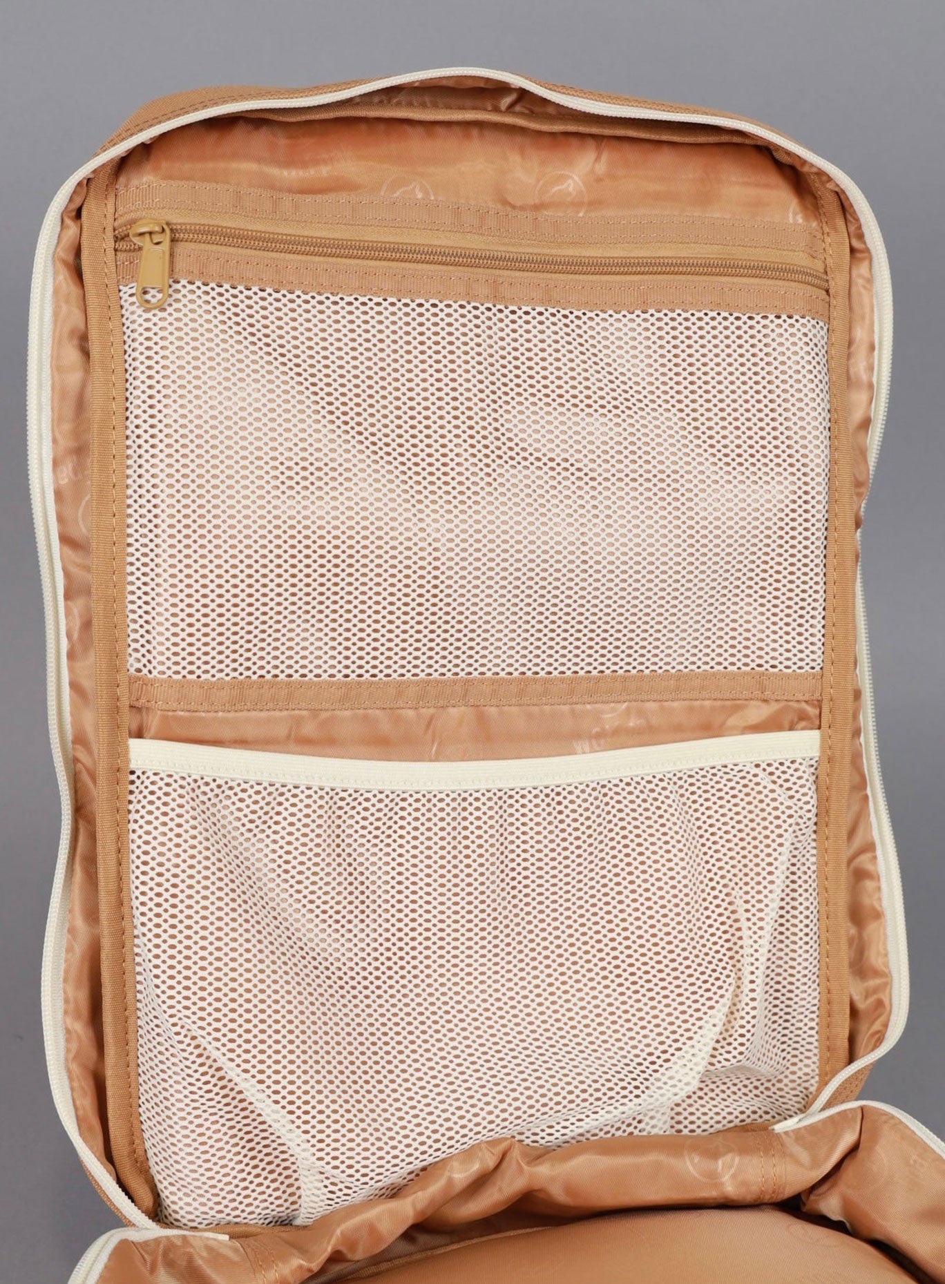 picture of the mini backpack from wolfpak in caramel color showing the biggest compartment 
