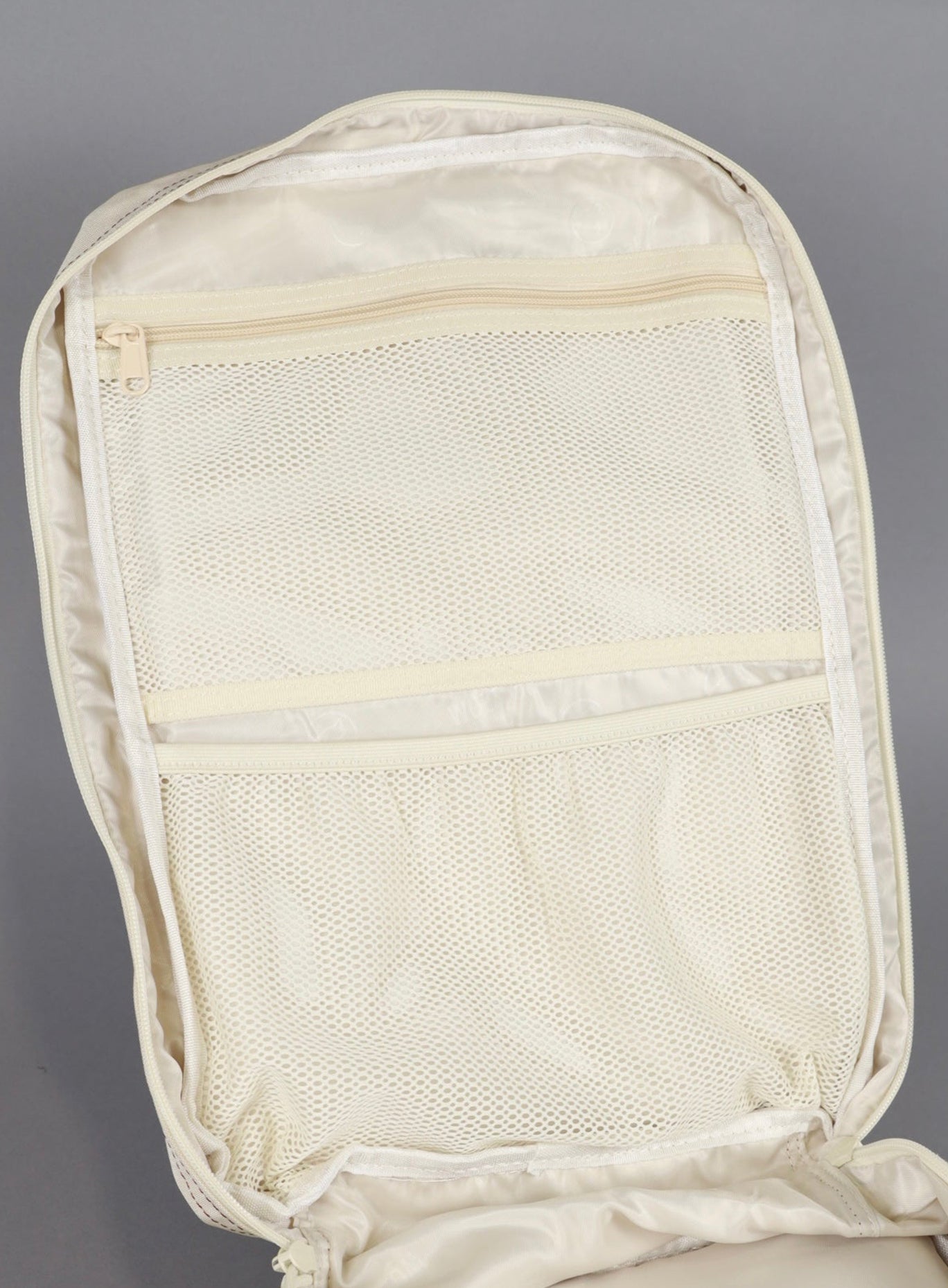 Picture of the inside mesh compartment of the wolfpak backpack in 35L in creme color 