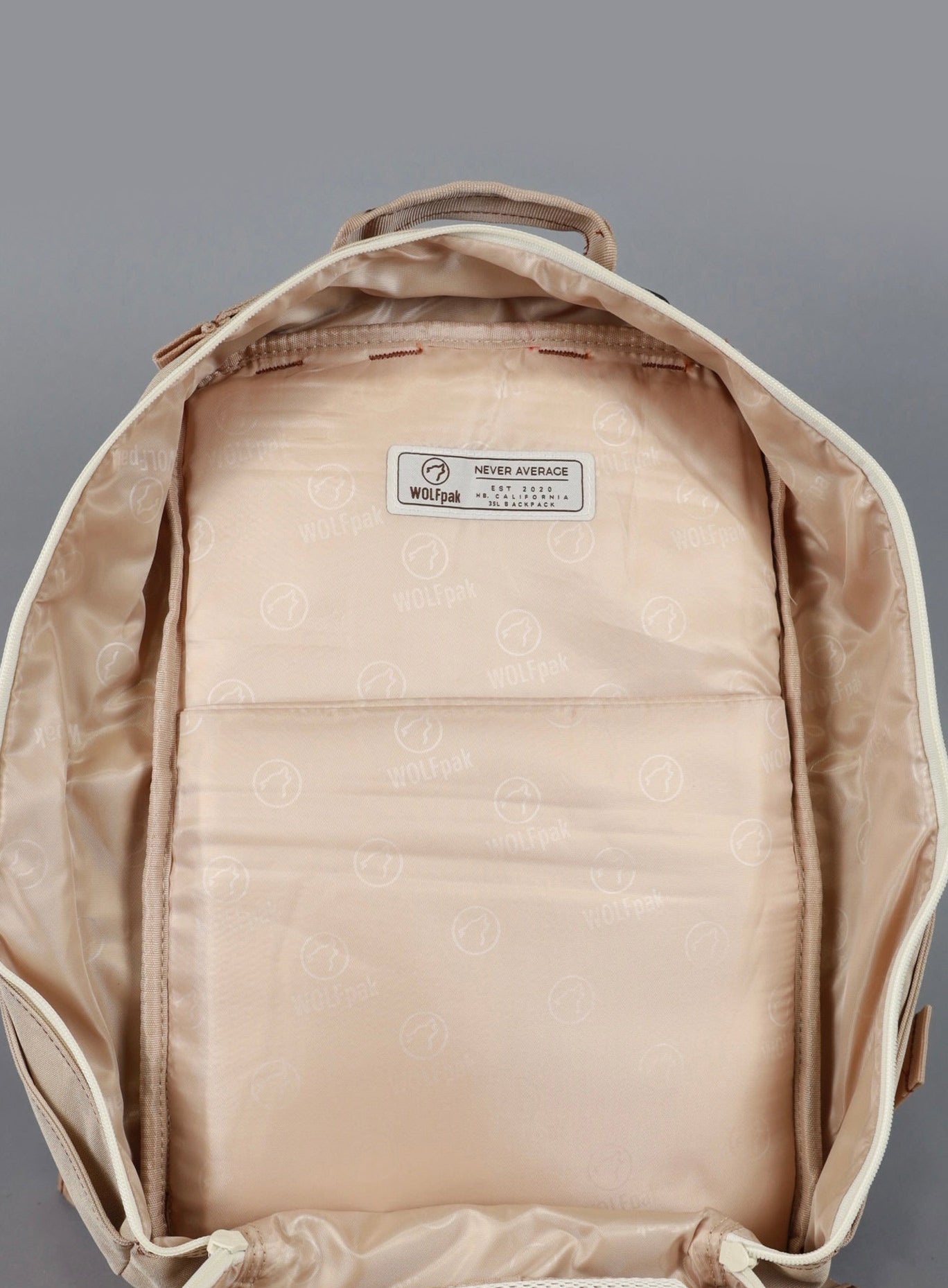 A picture of the company badge in the biggest compartment of a wolfpak backpack in 35L in latte color