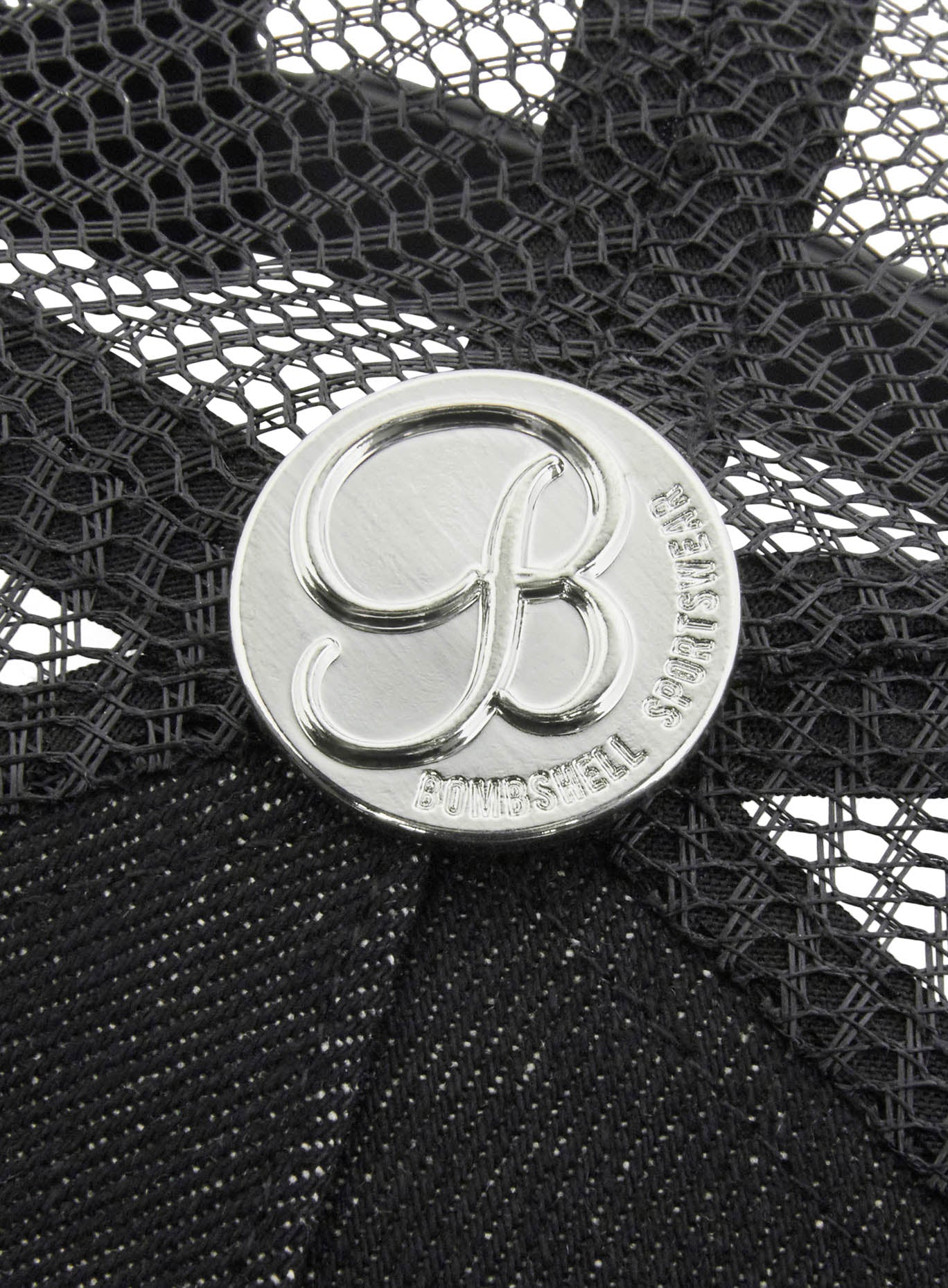 picture of the bombshell logo on our black denim crocodile har