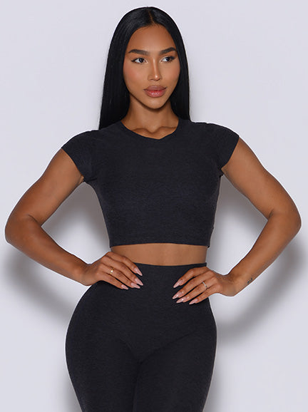 Close up front profile picture of a model in our Fit Fam Active Tee and the Movement Leggings in Onyx color