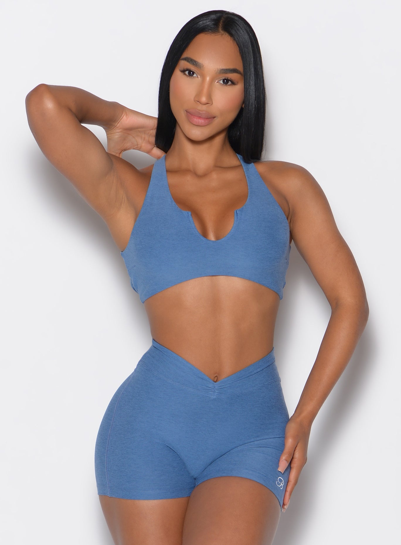 Model facing forward wearing our Ace Sports Bra and the matching shorts in Chambray color