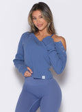 front profile view of a model with one hand resting on the next of the pullover wearing the Allure Pullover in blue chill color