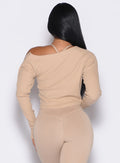 back profile view of a model wearing the Allure Pullover in glacial beige color