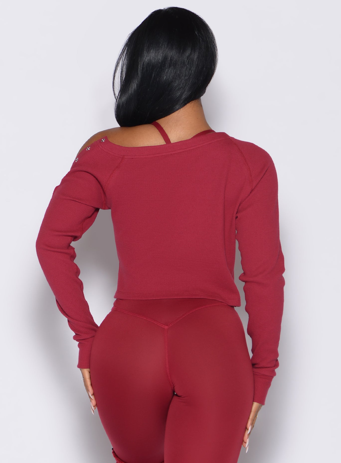 back profile view of a model wearing the Allure Pullover in red velvet color