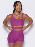 front profile view of a model wearing our Asymmetrical Slit Bra and the matching Tiny Waist Shorts in Bright Plum color
