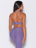 back profile view of a model wearing our backless bra in violet color along with the matching V back leggings