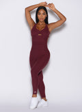 Model facing forward wearing our bombshell bodysuit in red wine color