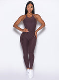 front profile view of our model with one hand on her waist wearing the Bombshell Bunny Bodysuit 2.0 in Peppercorn color