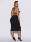 back  profile picture of a model facing to her right wearing our black bombshell bunny dress