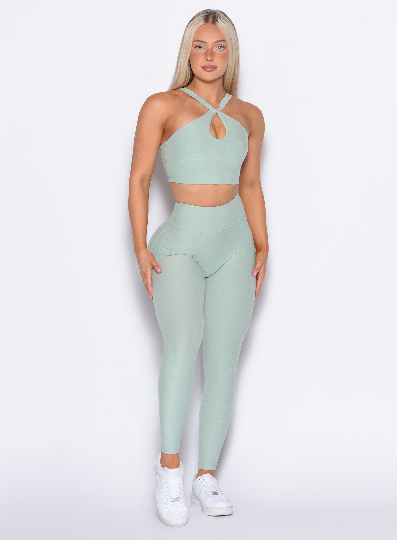 front profile view of our model wearing the Bombshell Bunny Leggings in soft aloe color paired with the matching top