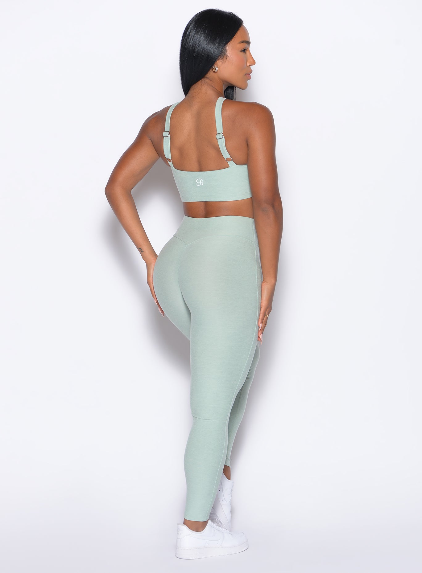 back right side profile view of our model wearing the Bombshell Bunny Leggings in soft aloe color