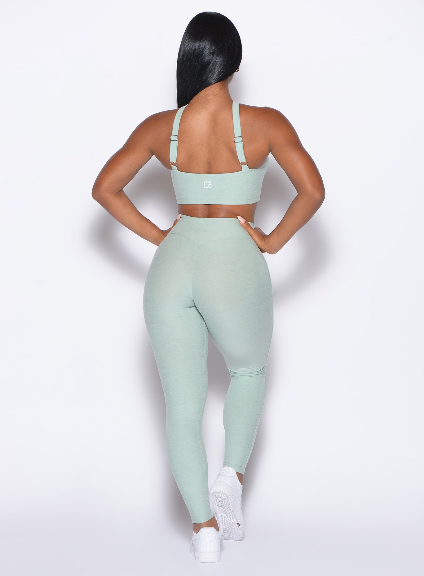 back profile view of our model wearing the Bombshell Bunny Leggings in soft aloe color