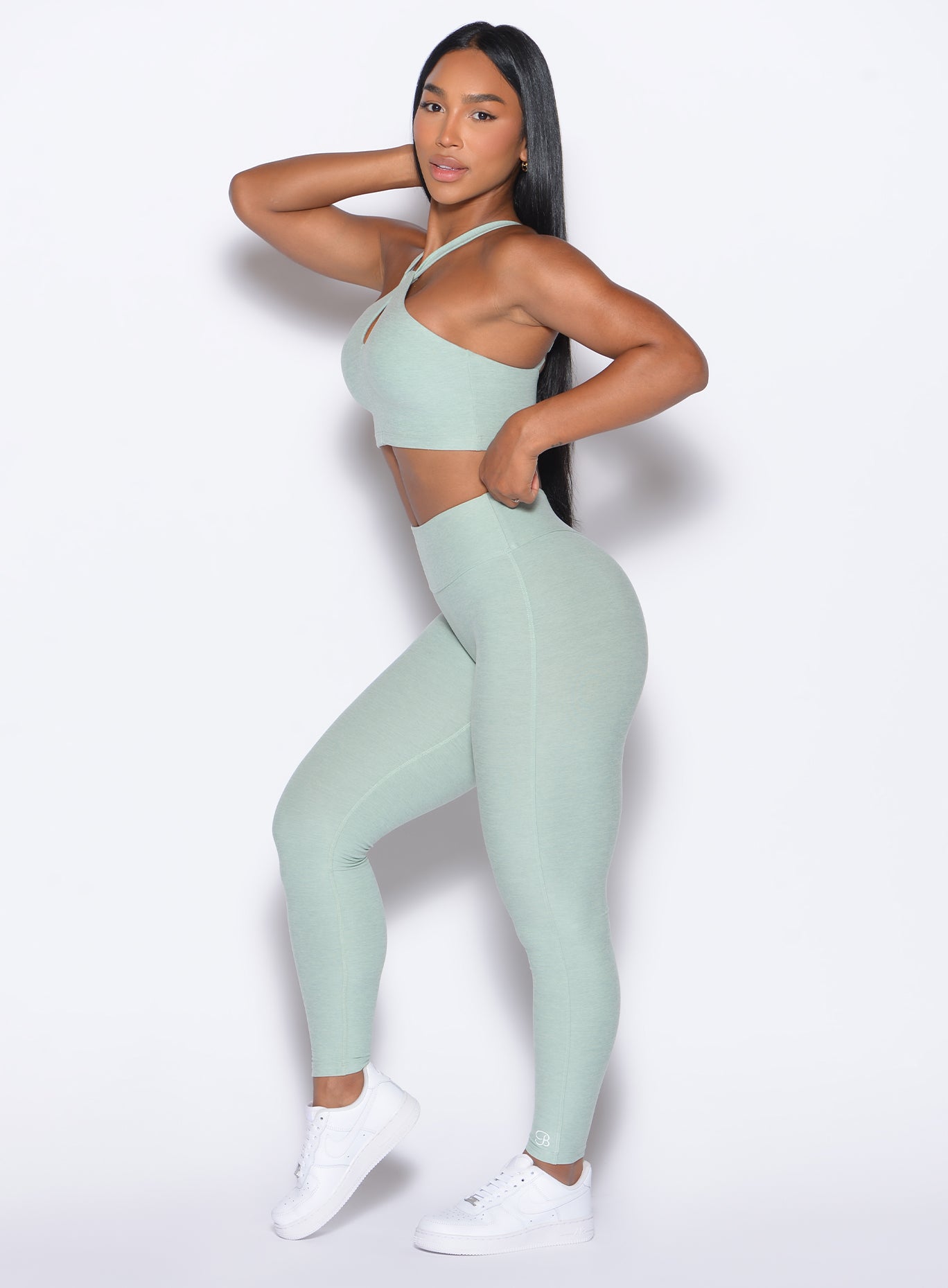 left side profile view of our model wearing the Bombshell Bunny Leggings in soft aloe color