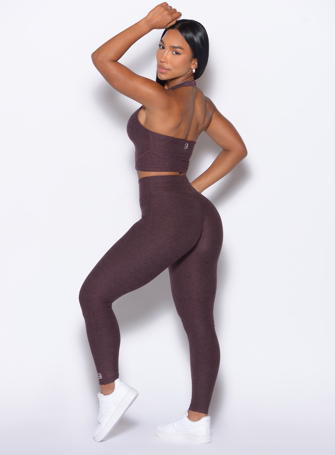 left side profile view of our model in a one hand on her forehead pose looking over her shoulder wearing the Bombshell Bunny Leggings in peppercorn color