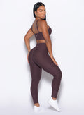 right side profile view of our model looking over her shoulder wearing the Bombshell Bunny Leggings in peppercorn color