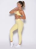 front left side profile view of a model wearing the Bombshell Bunny Leggings in soft yellow color