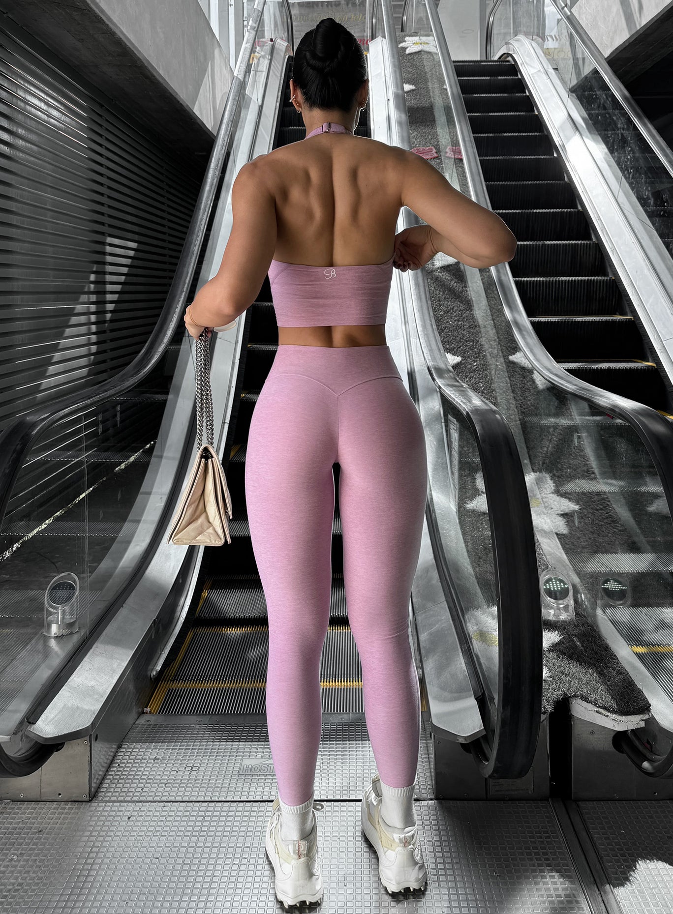 back view of model wearing the Bombshell Bunny  leggings and backless Lift Halter Bra in pink