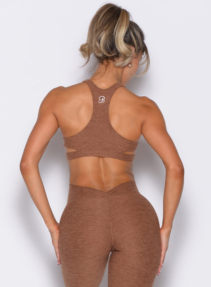 back profile view of a model wearing the Powerhouse bra in Coffee Bean color paired with the matching leggings 