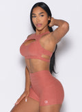 left side profile view of a model wearing the Powerhouse bra in Georgia Peach color