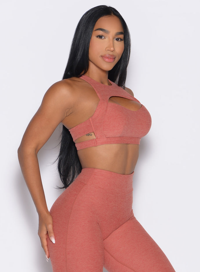 right side profile view of a model wearing the Powerhouse bra in Georgia Peach color