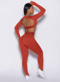 back right side profile view of our model wearing the Bombshell Active Leggings in red ochre color