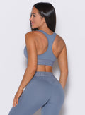 back profile view of our model wearing the Bombshell Active Bra in Flinstone color