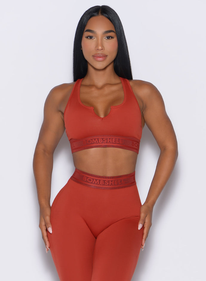 front profile view of our model wearing the Bombshell Active Bra in Red Ochre color