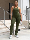 model facing forward with a big smile on her face wearing our bombshell bunny bodysuit in jungle color