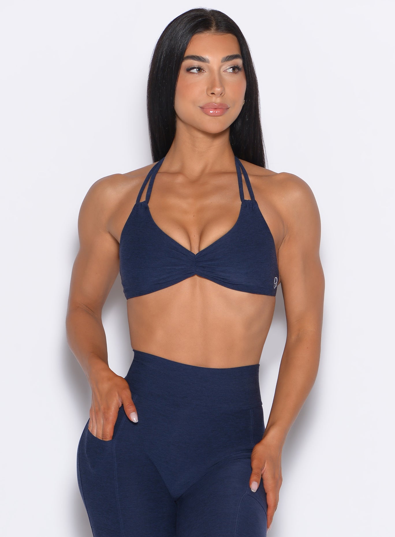 front profile view of our model looking to the left wearing the Butterfly Sports Bra in Cosmic Blue color