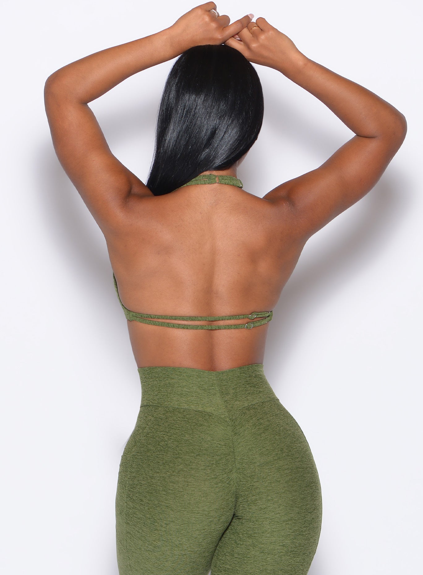 Back profile view of our model wearing the Butterfly Sports Bra in Juniper color