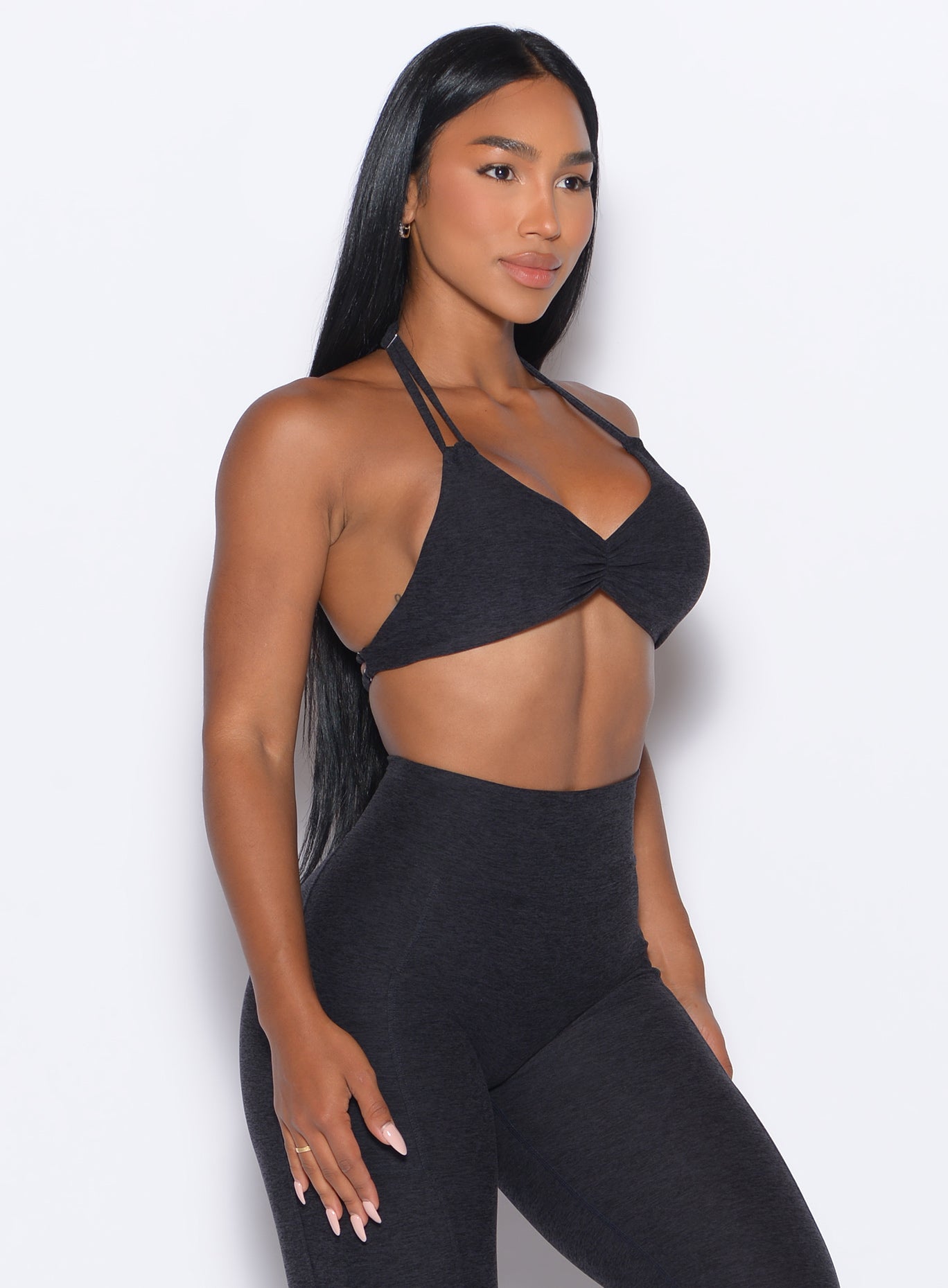 front right side profile view of our model wearing the Butterfly Sports Bra in Onyx color