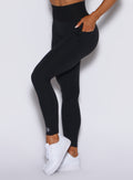 Zoomed in left side profile view of our black cincher leggings 